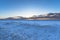 Landscape of the beach area Totally snow covered black sand beach with golden sunrise light under the clouds