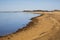 Landscape: Beach Shoreline with Still Blue Water and Sky