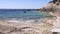 Landscape of beach with waves crashing on coral rock in Istria, Croatia. Waves breaking on stony beach, forming a spray.