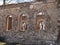 Landscape with beautiful abandoned church ruins, arched windows, stone walls, building without a roof