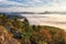 Landscape Beautiful autumn morning above deep forest valley.