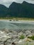 Landscape with beautiful green overgrown rocks at the fjord, beautiful sea water