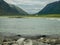 Landscape with beautiful green overgrown rocks at the fjord, beautiful sea water