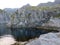 Landscape with beautiful green overgrown rocks at the fjord, beautiful sea water