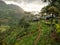 Landscape of beautiful mountain covered with jungle forest and tea plantations with small wooden houses
