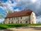 Landscape with a beautiful stone building, Sunday school house near TrikÄta church, Latvia