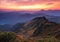 Landscape with beautiful sunset, cloudy sky and orange colorful horizon. Autumn morning in high mountains. Natural landscape.