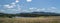 Landscape with blue sky and clouds, pond and field