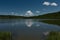 Landscape With Blue Sky, Green Vegetation, Lake