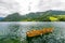 Landscape with a boat on lake against mountains. Austrian lake view, summer idyllic