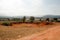 Landscape of Bomb craters field with village and mountains on background in Xieng Khouang Province, Laos.