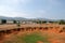 Landscape of Bomb craters field with village and mountains on background in Xieng Khouang Province, Laos.