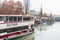 Landscape with buildings and cruise ship sailing at the riverbank of Donaukanal Danube cannal  in a rainy day,  , in Vienna,