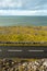 Landscape in Burren area by Atlantic ocean, West of Ireland. Small narrow asphalt road by the ocean, part of Wild Atlantic Way