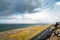 Landscape in Burren area by Atlantic ocean, West of Ireland. Small narrow asphalt road by the ocean, part of Wild Atlantic Way