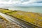 Landscape in Burren area by Atlantic ocean, West of Ireland. Small narrow asphalt road by the ocean, part of Wild Atlantic Way