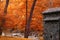 Landscape with cabin, river and Autumn trees.