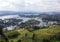 Landscape with calm lakes, green mountains, lush forests and some summer villas