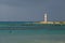 Landscape of the Cancun Lighthouse surrounded by the sea in the evening in Mexico