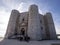 Landscape with Castel del Monte in beautiful sunset in perspective view with tourist waiting to enter