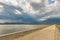 Landscape of causeway on idyllic water surface under overcast sky