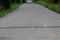 Landscape cement sloping roads with potholes can be dangerous, selectable focus, forest roads.