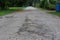 Landscape cement sloping roads with potholes can be dangerous, selectable focus, forest roads.