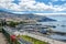 Landscape of the city and the port of Funchal from the hill. Flowers in the foreground