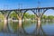 Landscape with classic arched bridge and it`s reflection on the Dnipro river the water in the Dnipro city, Ukraine