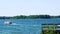 Landscape clip of a beautiful northern Minnesota lake on a sunny day with a dock, pontoons, boats and tubers.