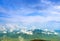 Landscape with clouds, mountains, blue sky and village.