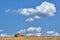 Landscape with clouds over a mown field with haystacks