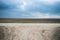 Landscape consisting of a plowed field road and sky. Belarusian rural landscape