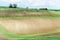 Landscape with curves of wavy rolling textured rural fields