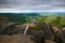 Landscape of Czech Republic. Rocky hill above small village. Stones with ferrous trail. Summer view of beautiful area Drabske