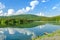 Landscape of the dam and lake on the mountain with tree and forest and the boat