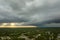 Landscape of dark ominous clouds forming on stormy sky before heavy thunderstorm over rural town area