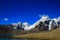 Landscape of deep blue sky and ice capped peaks of himalayan mountains with white clouds during day time