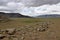 Landscape of a deserted area surrounded by hills under a cloudy sky on a gloomy day