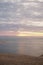 Landscape on a deserted empty Dune du Pilat. looking along the shore with foam waves on sand vast sea calm with grey skies and