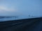 Landscape of deserted paved winter road climbs in snow