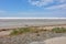 Landscape of a deserted salt lake. The texture of salt formations in the foreground. salt lake surface, dry salt lake, white salt