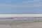 Landscape of a deserted salt lake. The texture of salt formations in the foreground. salt lake surface, dry salt lake, white salt