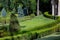 Landscape design with boxwood hedges and glade with a lawn.