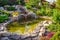 Landscape design of home garden close-up. Beautiful landscaping with small pond and waterfall