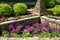 Landscape design of home garden, landscaping with flowers and stone retaining walls