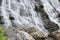 Landscape detail of waterfall over rocks in Summer long exposure