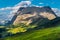 Landscape of Dolomites with green meadows, blue sky, white clouds and rocky mountains. Italian Dolomites landscape. Beauty of natu