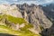 Landscape of Dolomites with green meadows, blue sky, white clouds and rocky mountains. Italian Dolomites landscape. Beauty of natu