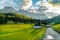 Landscape of Dolomites with green meadows, blue sky, white clouds and rocky mountains. Italian Dolomites landscape. Beauty of natu